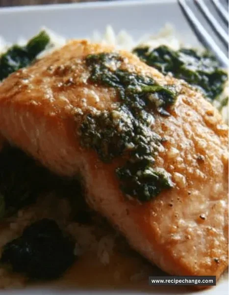 Easy sheet pan garlic butter salmon served with spinach