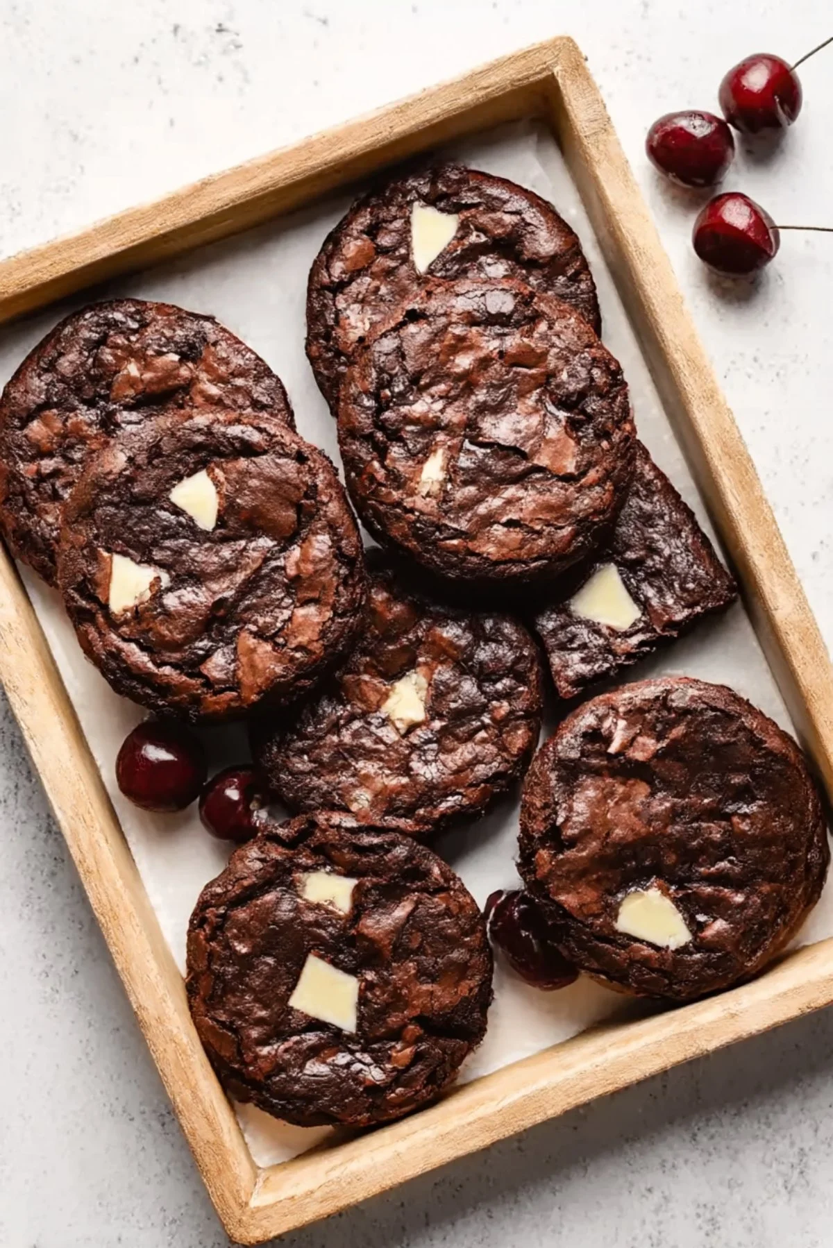 Delicious easy cherry brownies topped with fresh cherries and chocolate frosting.