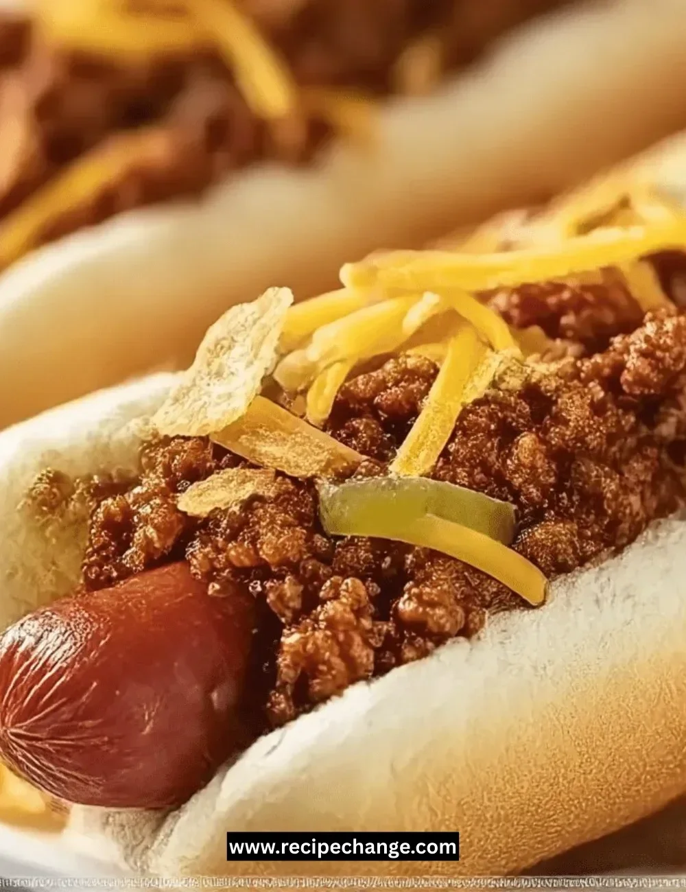 Pink strawberry cinnamon rolls topped with icing on a plate