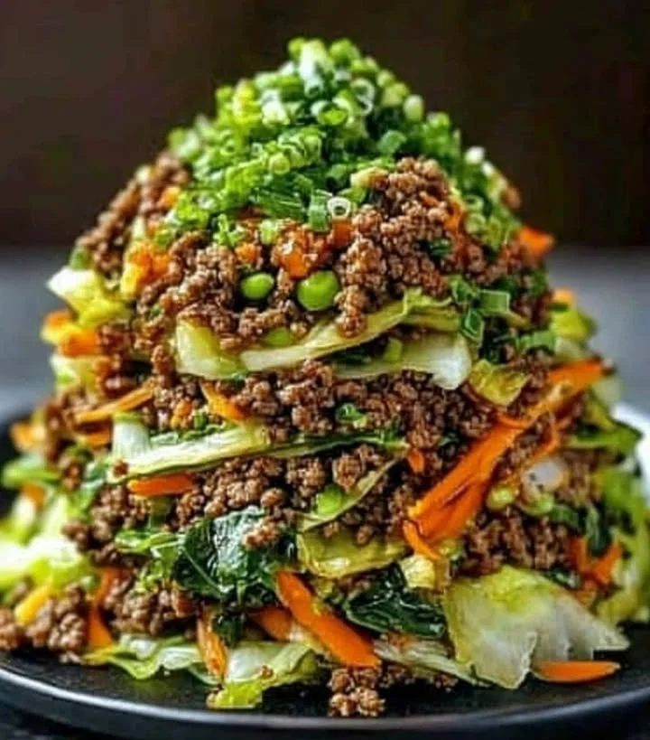 Delicious beef cabbage stir fry stack served in a bowl with vibrant vegetables.