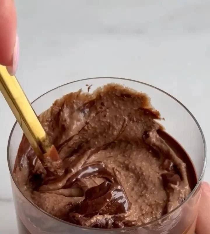 Delicious brownie batter overnight oats in a vibrant bowl with toppings.