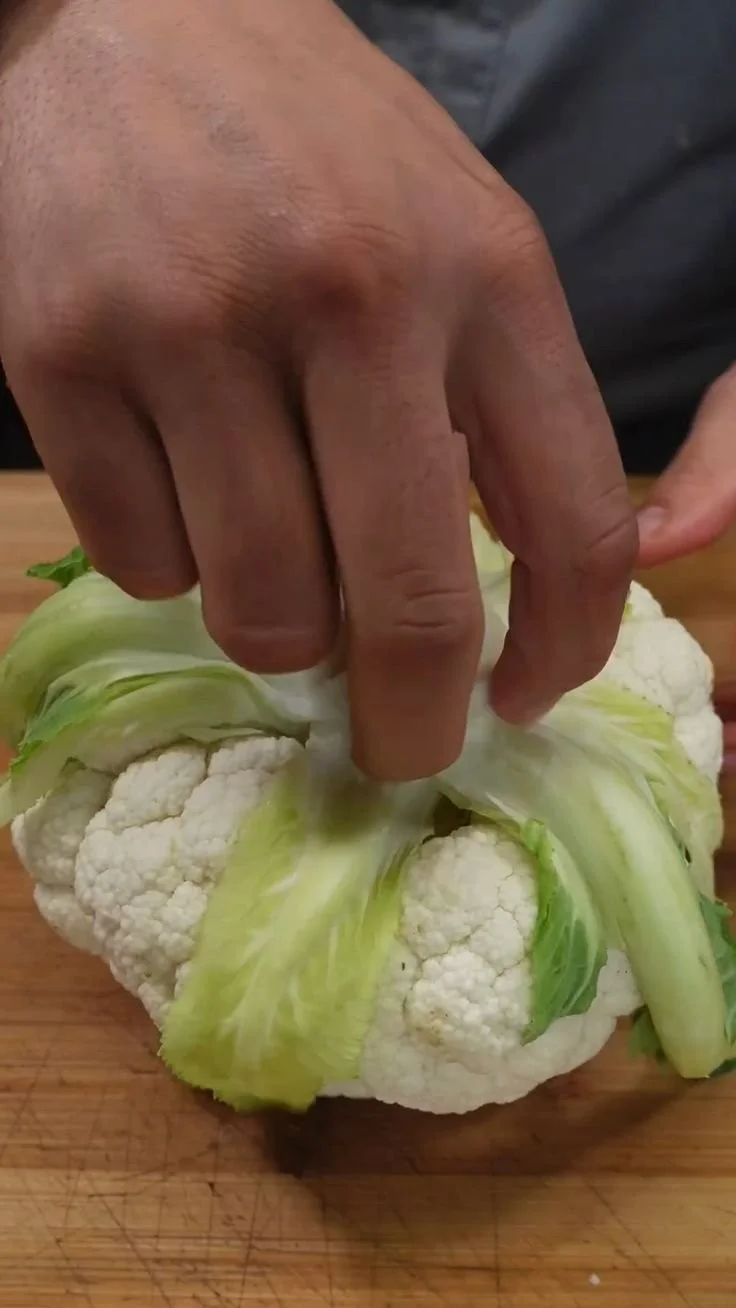 Baked Cauliflower Parmesan dish topped with melted cheese and herbs
