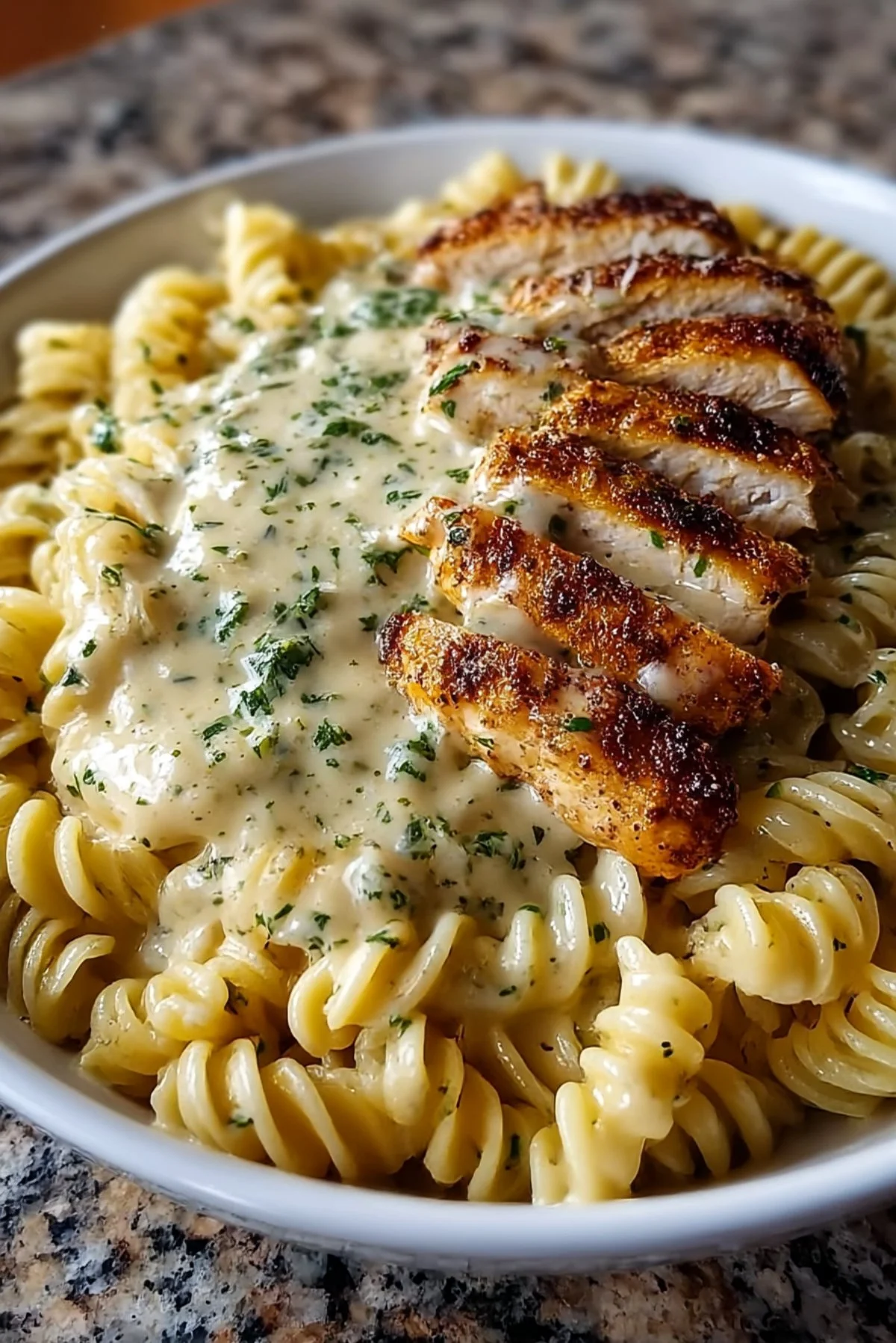 Cheesy Beef Rigatoni Bake topped with melted cheese and fresh herbs