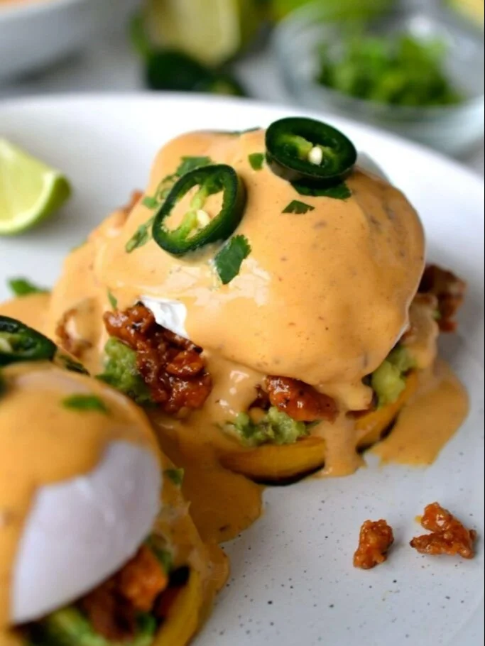Delicious Mexican Eggs Benedict topped with creamy sauce and vibrant ingredients