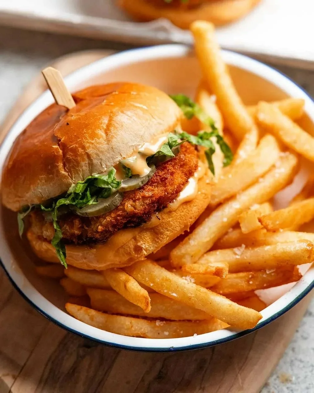 Delicious homemade prawn burgers served with fresh toppings and a side of fries.