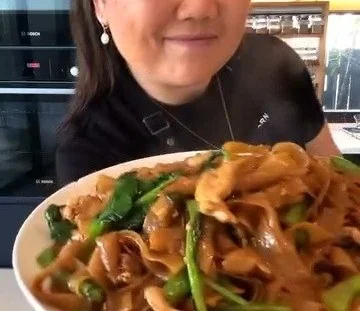Delicious bowl of stir-fried noodles with colorful vegetables and protein.