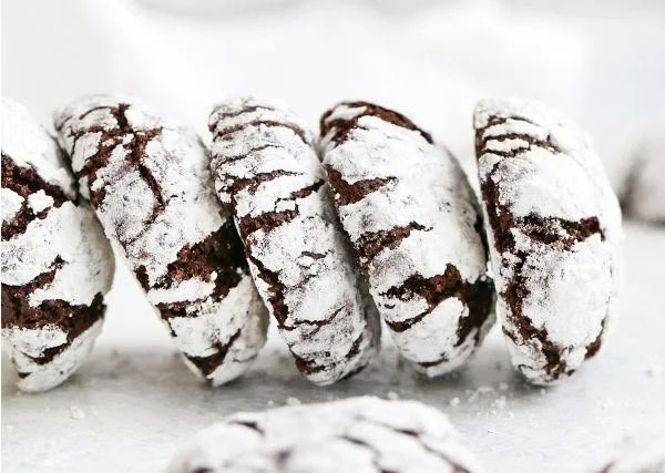 Freshly baked Chocolate Crinkle Cookies with powdered sugar coating