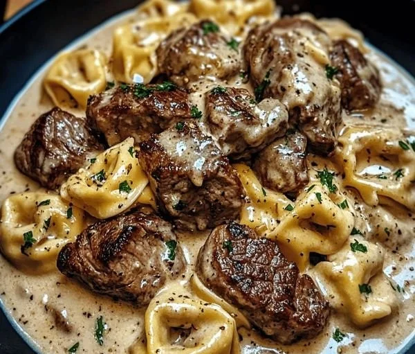 Cracked Garlic Steak Tortellini served in Creamhouse sauce on a plate