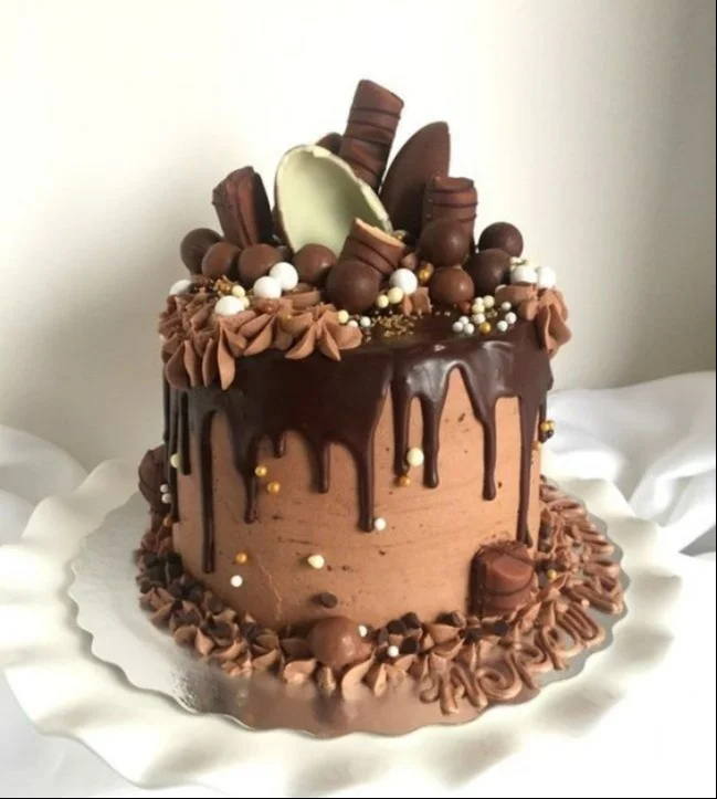 Delicious dripping cake with colorful icing and rich chocolate ganache