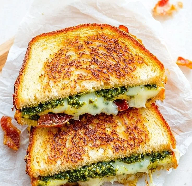 A delicious pesto grilled cheese sandwich with melted cheese and vibrant pesto spread