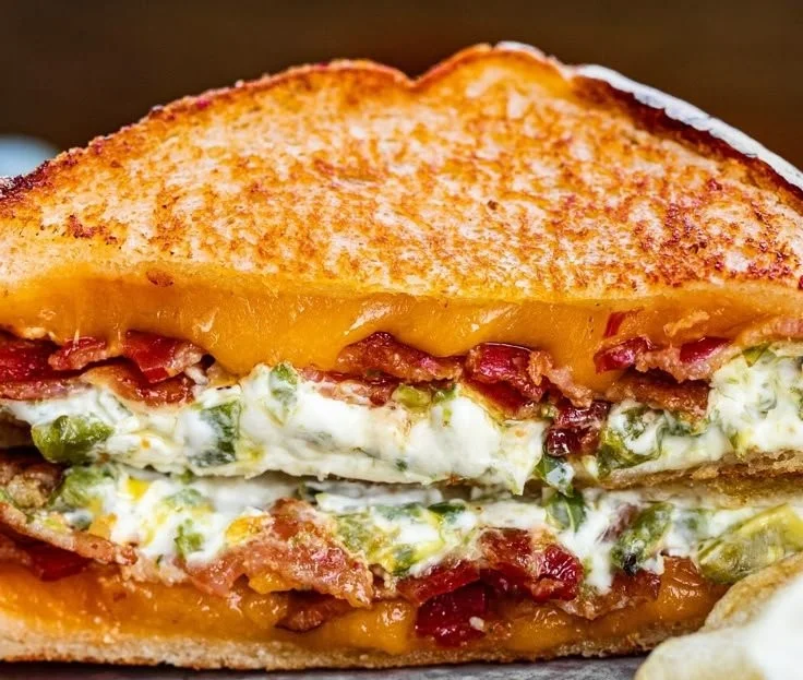Roasted jalapeno popper grilled cheese sandwich showcasing melted cheese and jalapenos.