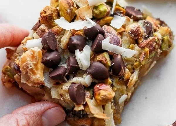 Delicious homemade Seven Layer Bars featuring chocolate, coconut, and nuts.
