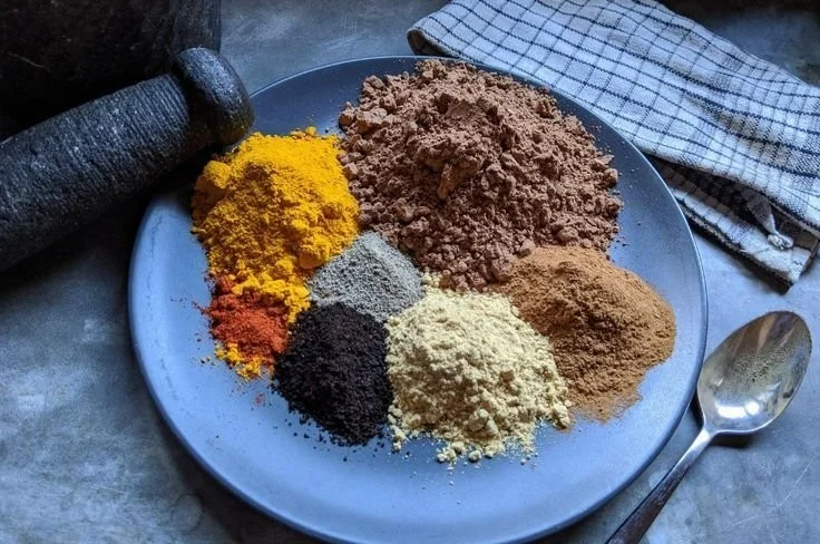 A steaming mug of spiced hot cocoa topped with whipped cream and cinnamon