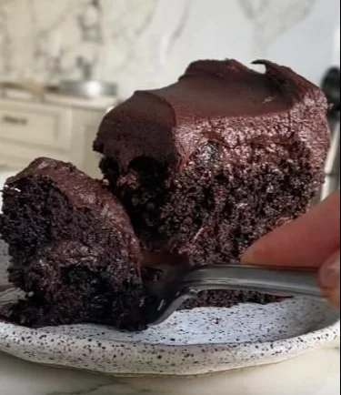 Vegan gluten free chocolate cake topped with rich chocolate frosting