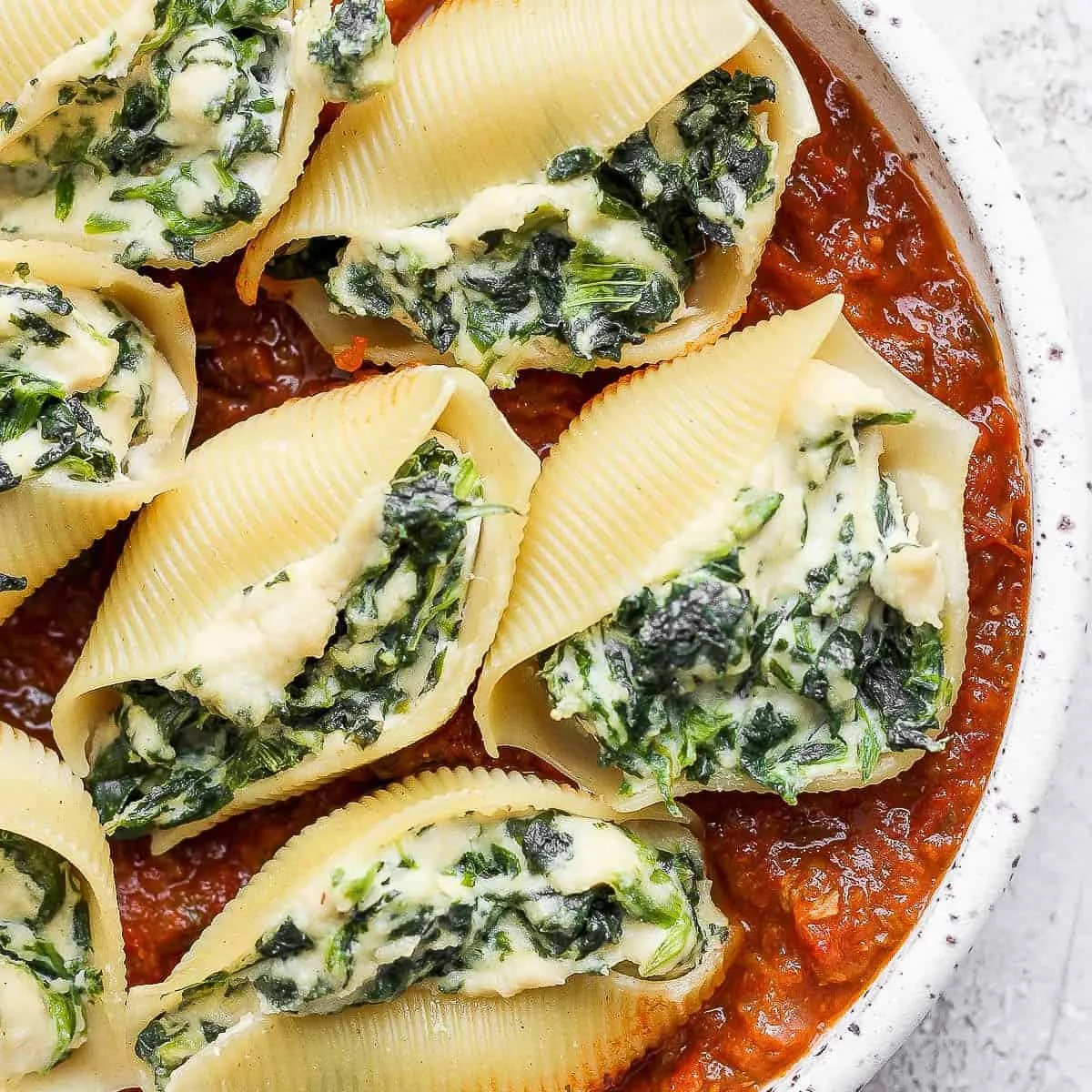 Plate of vegan stuffed shells filled with plant-based ingredients, ready to eat.
