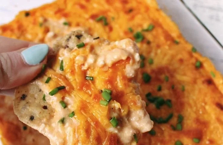 Vegetarian Cheesy White Bean Buffalo Dip served in a bowl with veggies