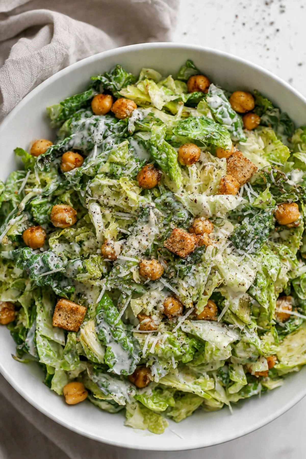 Brussels Caesar Salad with romaine and Brussels sprouts topped with dressing and croutons