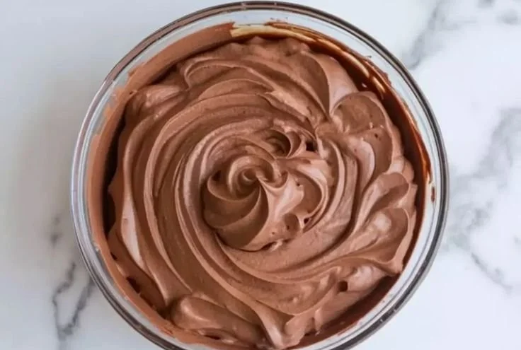 Decadent chocolate mousse cake filling ready for baking