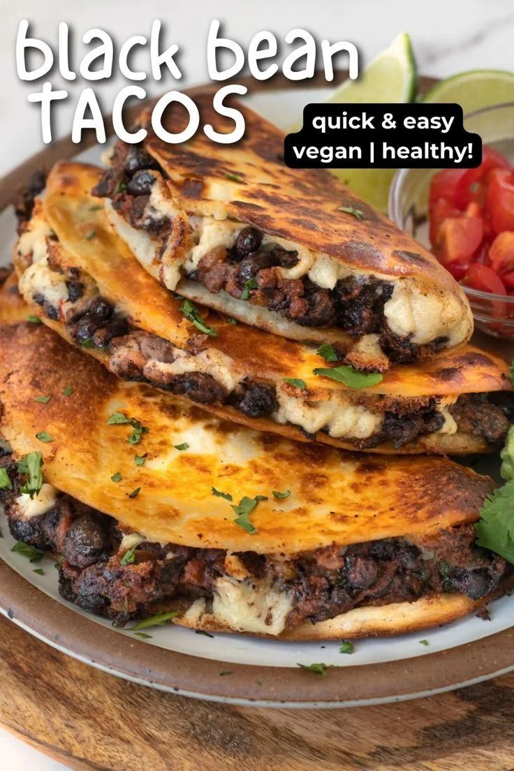 Plate of crispy black bean tacos garnished with fresh toppings
