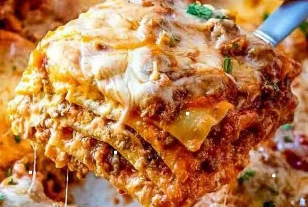 Easy no boil lasagna dish served with fresh herbs and melted cheese