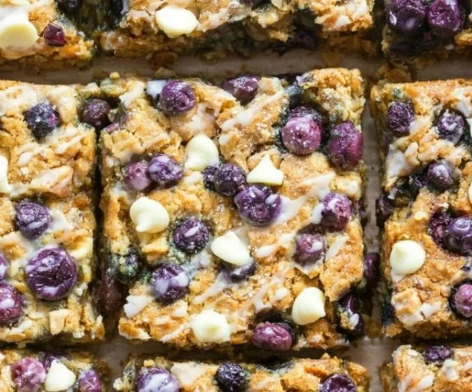 Bowl of healthy blueberry baked oatmeal topped with fresh blueberries and almonds