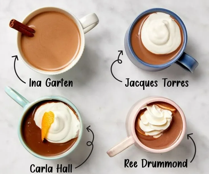 A steaming mug of rich hot cocoa topped with whipped cream and chocolate shavings.