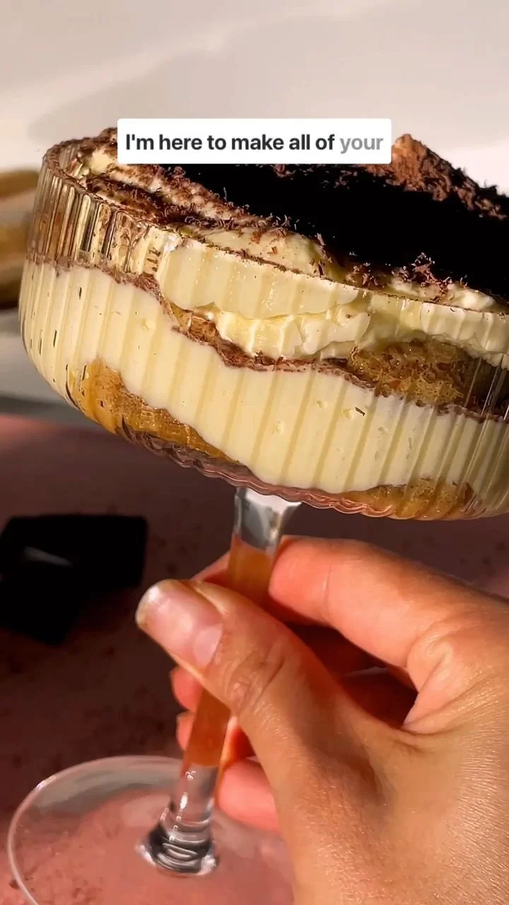 Delicious individual tiramisu cups topped with cocoa and coffee flavor