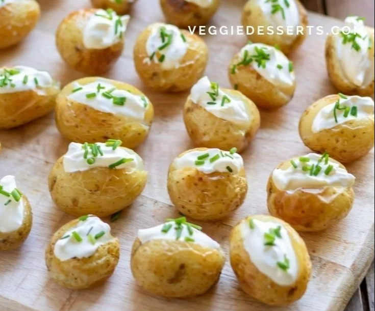 Mini baked potatoes topped with cheese and herbs