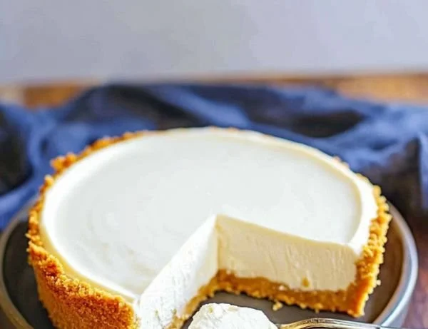 Delicious no-bake cheesecake topped with fresh berries on a plate