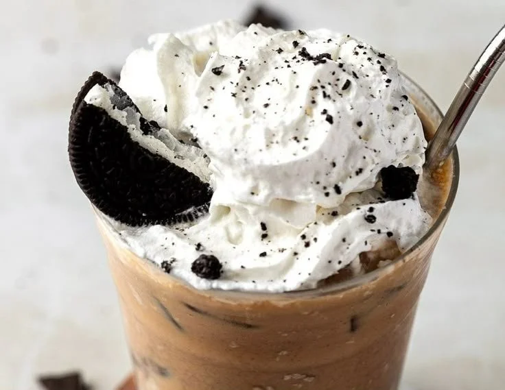 Delicious Oreo Iced Coffee served in a glass with cookie garnishes