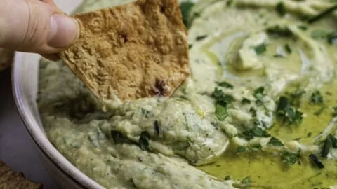 Homemade white bean dip served with fresh vegetables and crackers