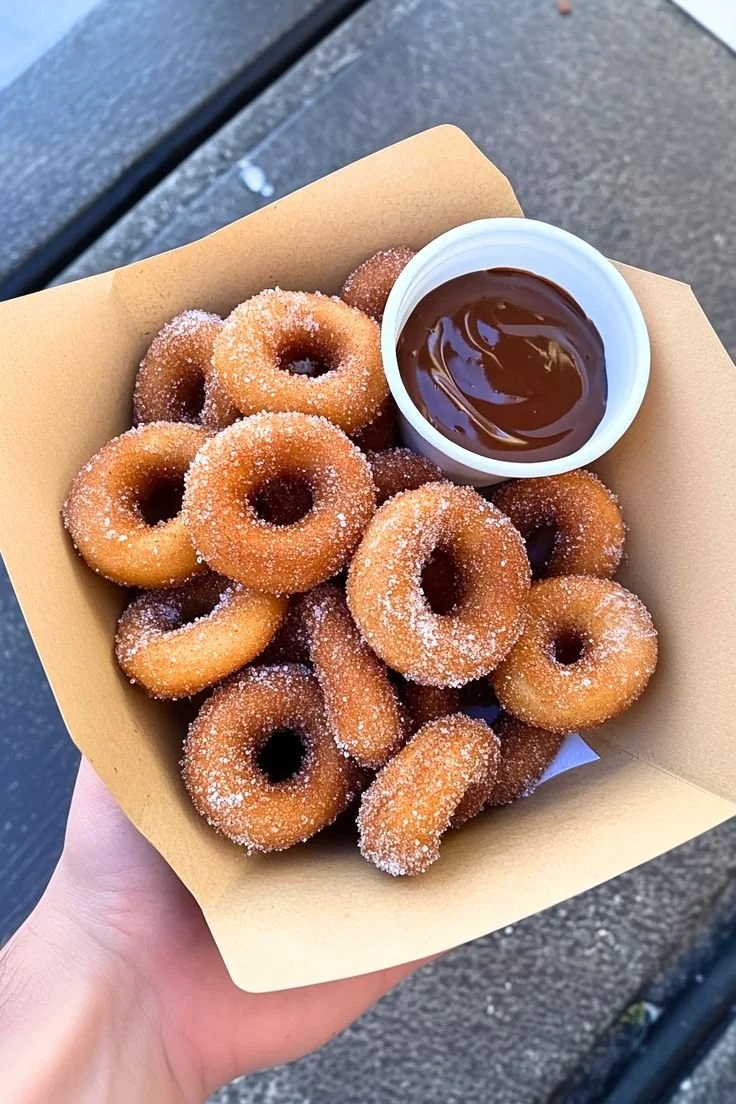 Plate of freshly made Churro Donut Bites rolled in cinnamon sugar