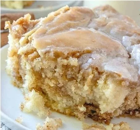 Delicious cinnamon roll cake topped with icing, perfect for dessert lovers