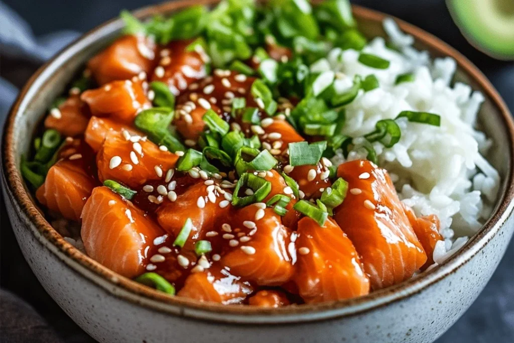 Crispy salmon rice bowl topped with fresh vegetables and sauce
