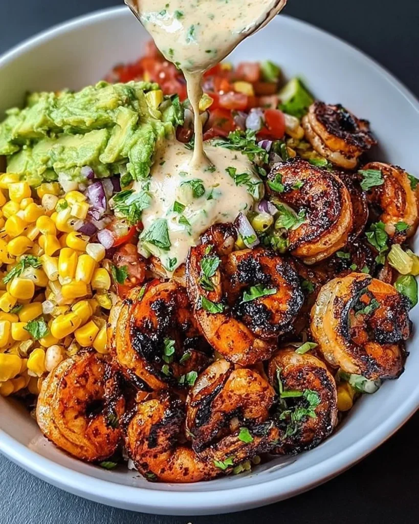 Grilled shrimp bowl with avocado, corn salsa, and creamy garlic sauce