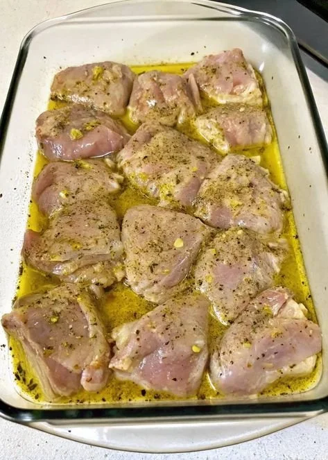 Baked Greek Lemon Chicken garnished with herbs and lemon slices