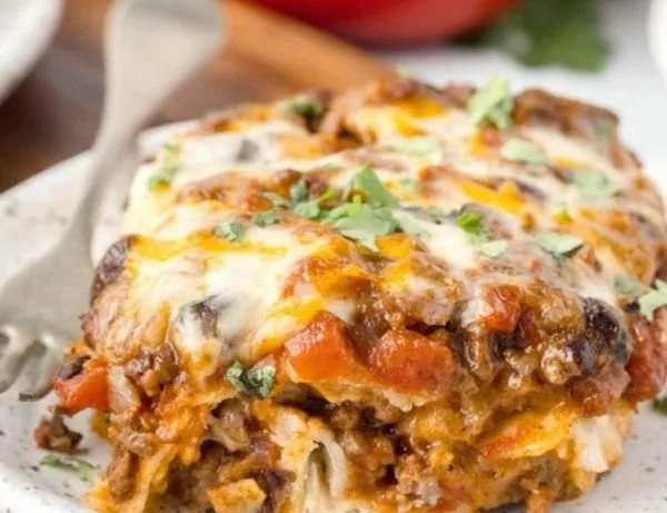 Delicious Beef Enchilada Casserole served hot with toppings