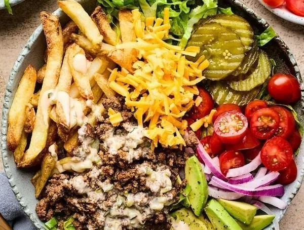 Delicious cheeseburger bowls topped with lettuce, tomatoes, and cheese
