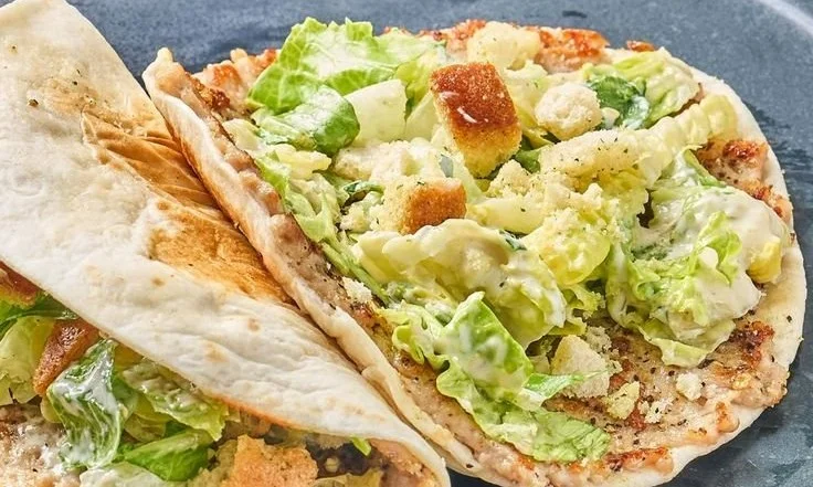 Chicken Caesar Smashed Tacos topped with lettuce and Parmesan cheese