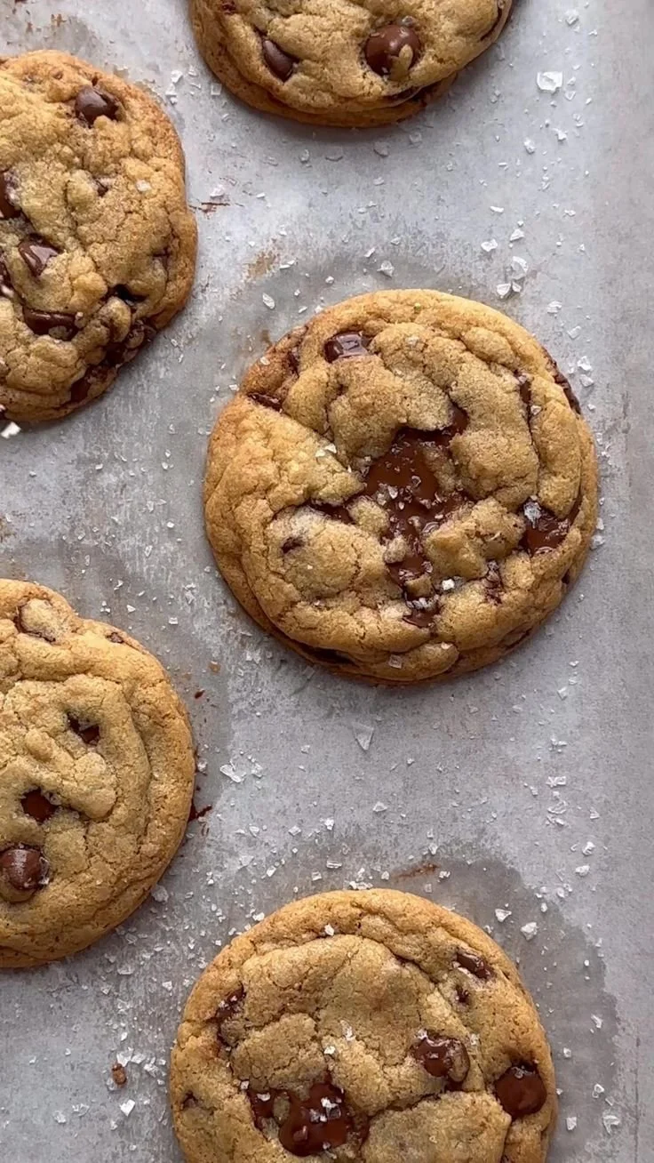 Freshly baked chocolate chip cookies on a cooling rack