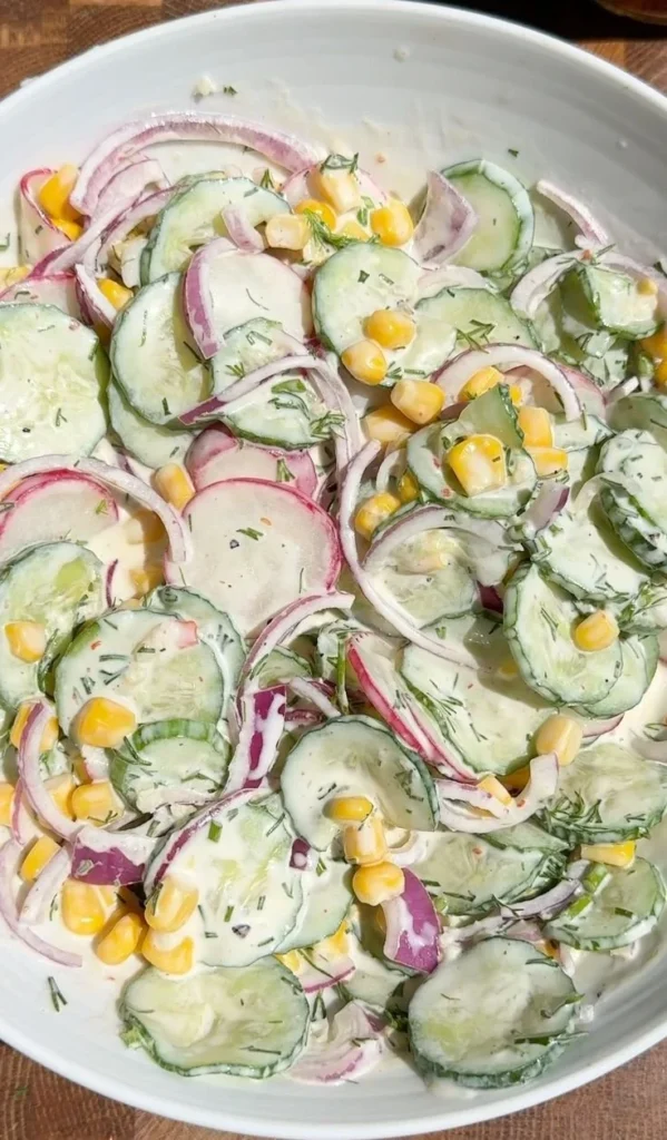 A colorful Greek yogurt salad featuring fresh vegetables and herbs