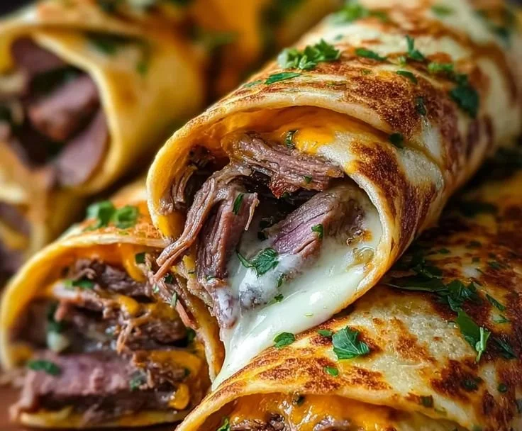 Delicious French Dip Tortilla Roll Ups served with au jus for dipping