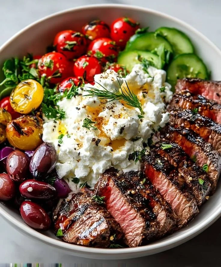 Delicious Mediterranean steak bowls with fresh vegetables and flavorful ingredients.