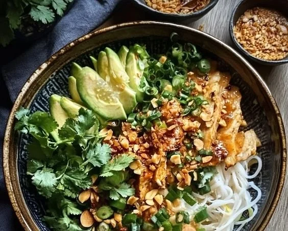Delicious Thai Peanut Chicken Noodle Bowl topped with fresh herbs and vegetables