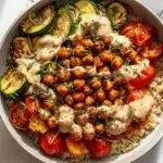 Colorful roasted chickpea and veggie bowl served in a rustic dish.