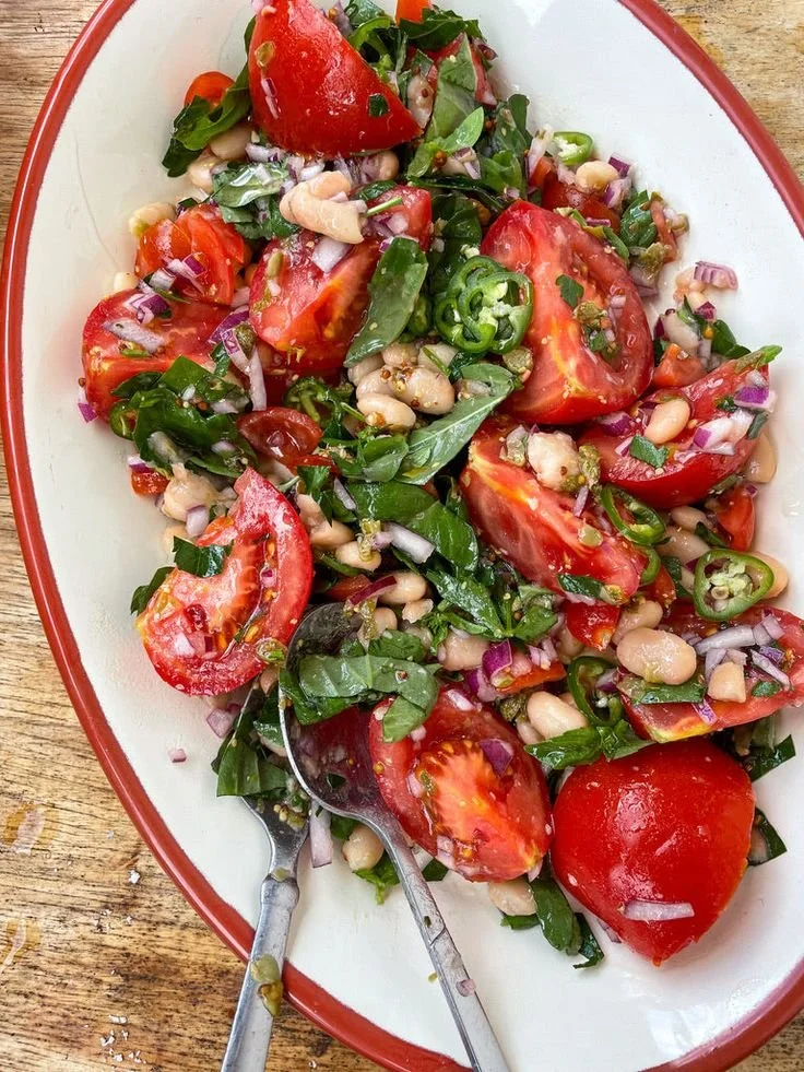 Delicious Tomato and Creamy Bean Toast topped with fresh herbs.
