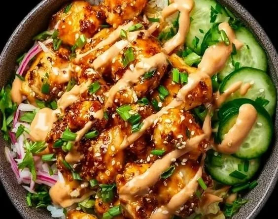 Crispy chicken with creamy spicy sauce served over jasmine rice