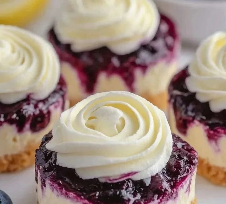 Healthy mini lemon blueberry cheesecakes topped with fresh blueberries.