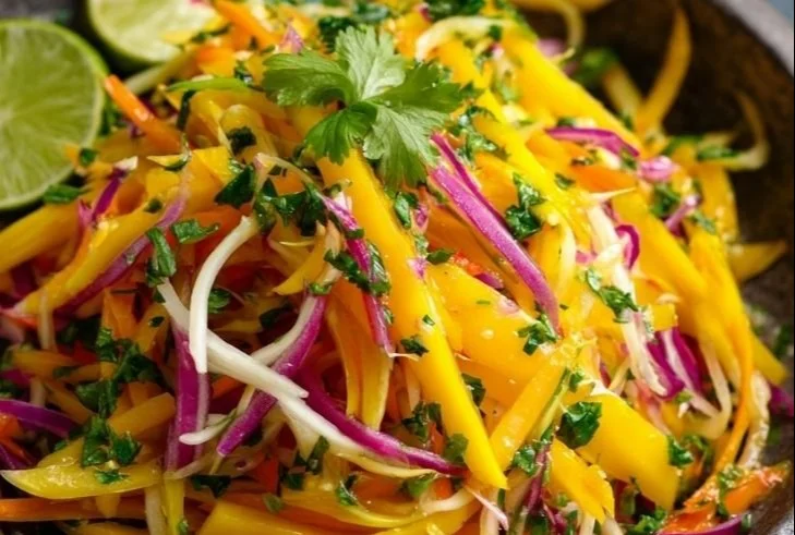 Vibrant mango slaw with colorful vegetables in a bowl