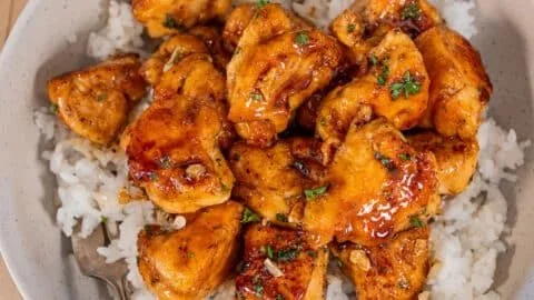 Plate of Minute Honey Garlic Chicken Bites garnished with green onions.
